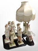 A group of Italian figurines of ladies on plinths, and a further table lamp with tasselled shade.