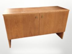 A 20th century Danish teak double door low cabinet,