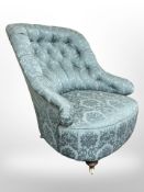 A late Victorian mahogany ladies armchair in blue floral upholstery,