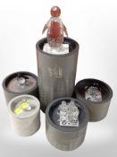 Five boxed Swarovski crystal figures of penguins, including a group of three penguins on stand.
