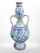 An Islamic-style tin-glazed faience twin-handled vase, height 45cm.