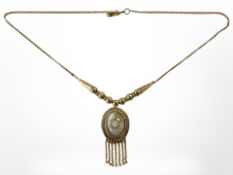 A Continental yellow metal necklace with cabochon stone pendant, stamped 875.