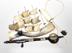 A carved horn model of a ship and a two-stringed instrument, length 56cm.
