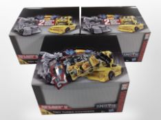 Three Hasbro Transformers models, boxed, and a further miniature in bag.
