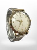 A 9ct yellow gold Gentleman's Omega Automatic wrist watch, on gold plated strap.