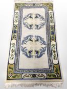 A Chinese rug on cream ground, 185cm x 92cm.