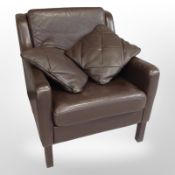A Late 20th century Danish brown stitched leather armchair with two similar cushions,