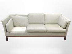 A late 20th century Danish three seater settee in green upholstery, lacking one cushion,