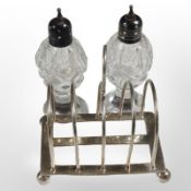 A pair of German Interwar period cut crystal pepperettes with silver tops, height 10cm,