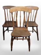 Three 19th-century elm spindle back kitchen chairs.