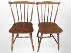 A pair of 20th century beech spindle back dining chairs