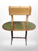 An extending oval occasional table with leather-inset top, together with a concertina sewing box.