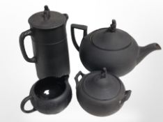 Four pieces of Wedgwood black basalt tea ware, tallest 18cm (af).