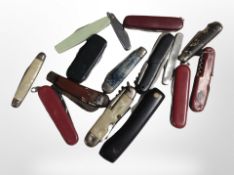 A group of folding pocket knives, Swiss Army knives, etc.