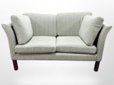 A Danish Hurup two-seater settee, upholstered in light green and white striped fabric,