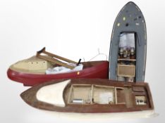 Three large model boat hulls, largest 115cm long.