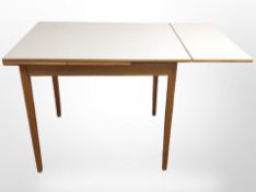 A mid-20th century melamine-topped extending kitchen dining table,