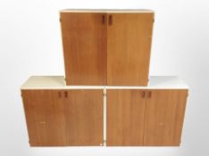 Three mid 20th century Danish teak double door stackable cupboards,