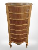 A continental walnut serpentine-front seven-drawer tall boy with gilt metal mounts,
