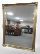 A Victorian-style gilt and bevelled overmantle mirror, 137cm x 106cm.