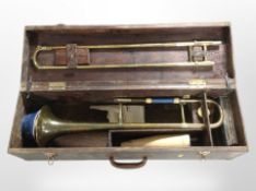 A Selmer Invicta brass trombone, in stained pine carry case,