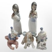 A Lladró figure of a seated clown and four further Nao figures, tallest 23cm.