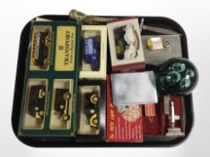 A group of die-cast cars including Ringtons, together with a green glass paperweight,