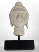 A bust of Buddha on plinth, height 36cm.