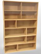 A 20th century Danish blond oak three section bookcase, with sliding glass doors above,