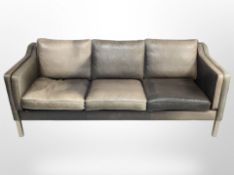 A late 20th century Danish three seater settee, upholstered in faded black leather,