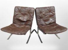 A pair of 20th century Danish chrome framed lounge chairs with brown studded leather cushions,