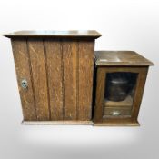A late-Victorian oak smoker's cabinet and a further oak single-door cabinet with shelved interior,
