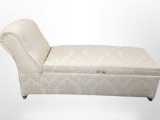 A 20th century storage chaise longue on castors,