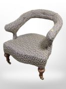 A Regency style mahogany horseshoe shaped armchair, in blue classical upholstery,
