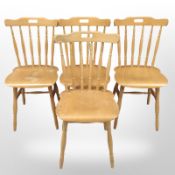 A set of four 20th century beech spindle back dining chairs