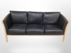 A late 20th century Danish stitched black leather beech framed three seater settee,