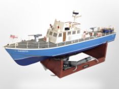 A scale model remote control Royal Malaysian police boat, on wooden stand, length 112cm.
