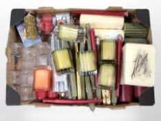 A large quantity of candles and candle holders.