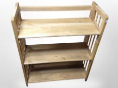 A contemporary pine three-tier shelf, width 70cm.