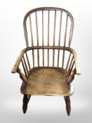 A 19th century elm spindle back armchair,