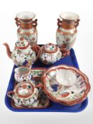 A group of Japanese kutani porcelain wares including pair of twin-handled vases and several pieces