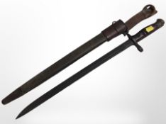 An American WWI Remington bayonet with 43cm single-edged blade, dated 1918, in scabbard.