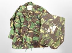 A DPM jacket and trousers, together with several army cap badges.