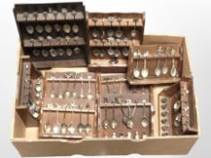 Several spoon racks containing a large quantity of collector's spoons and thimbles.