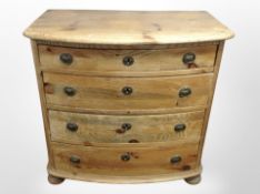 A 19th century Scandinavian pine bow-front four drawer chest on bun feet,