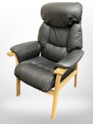 An oak framed black stitched leather armchair,