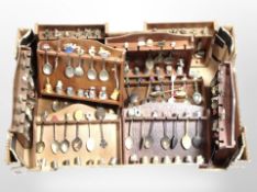 Several spoon racks containing a large quantity of collector's spoons and thimbles.