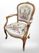 A continental carved beech salon armchair in tapestry upholstery,