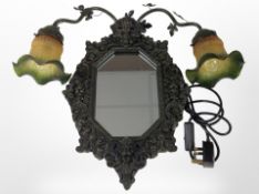 An Art Nouveau style mirror flanked by a pair of lamps with two-tone glass shades,