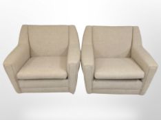 A pair of 20th century lounge armchairs in oak meal fabric, raised on castors,